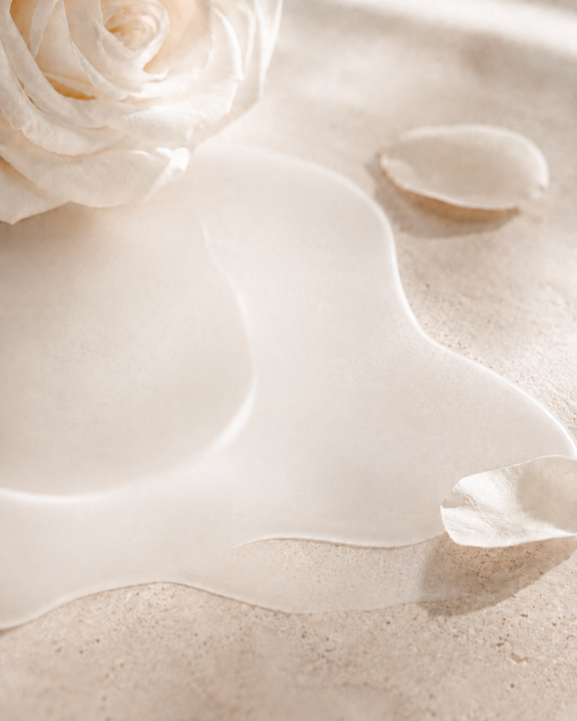 Soft white rose beside a sheer, milky hydration texture.
